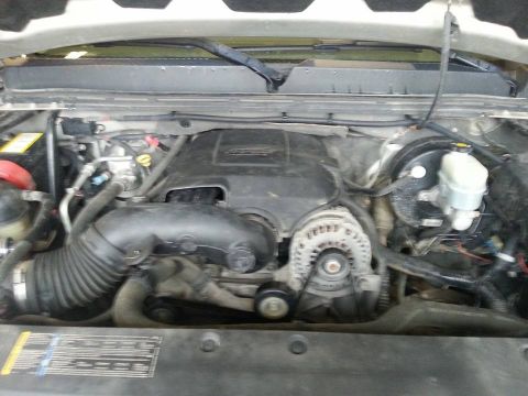 1995 Ford F-150 - The engine bay of a vehicle is shown, the alternator, air intake, and brake fluid reservoir.