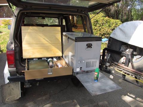 1990 Ford Bronco II - Drawer contains often-used items such as a Coleman stove, lantern, propane, and other odds and ends. Fridge slide has a shelf that pulls ou…