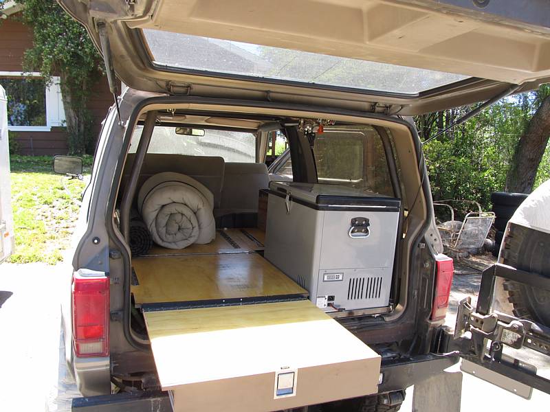 Drawer extends to provide a sleep platform. It's mounted on 500 lb rated Accuride drawer slides, plenty sturdy enough to sit on the end of it with it fully extended.