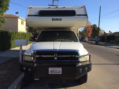 1997 Dodge 3500 - A 1997 Dodge 3500 pickup truck is equipped with a Lance camper shell, seen from the front.