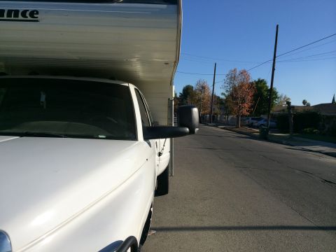 1997 Dodge 3500 - Side view of a white truck fitted with a camper shell. The word 'RANCE' is visible on the side of the camper.