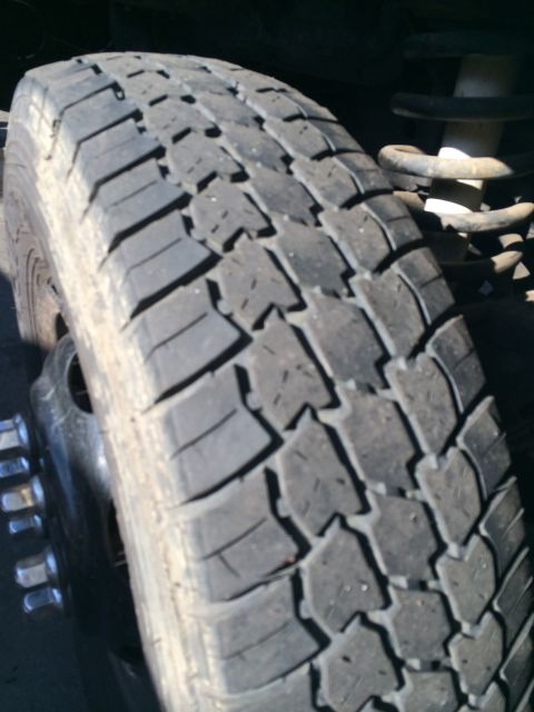 1997 Dodge 3500 - A close-up view of a truck's tire and suspension components.
