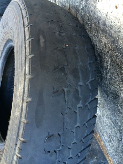 1997 Dodge 3500 - A close-up view of a heavily worn tire, showing significant damage to the tread and sidewall.
