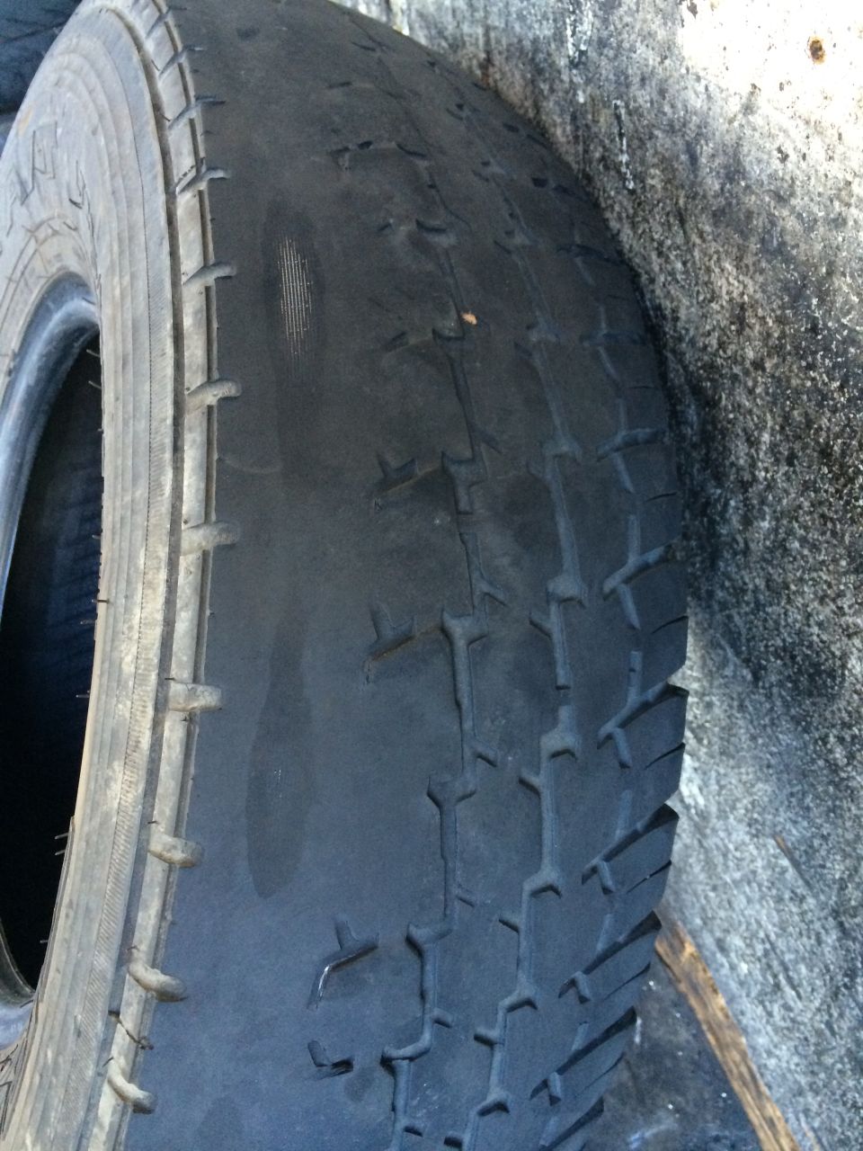 Worn tire with visible cracks and tread wear