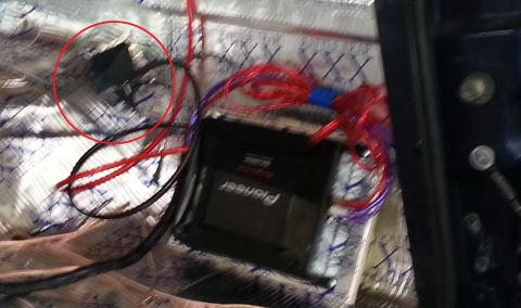 1994 Ford Bronco - Wiring for a Pioneer amplifier is visible, installed over sound deadening material.