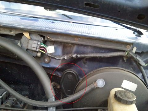 1994 Ford Bronco - Close-up view of the engine bay, focusing on the wiring harness and brake booster assembly.