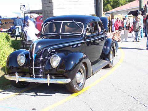 1971 Ford Ranchero - Classic black 1939 Ford Coupe on display at an outdoor event.
