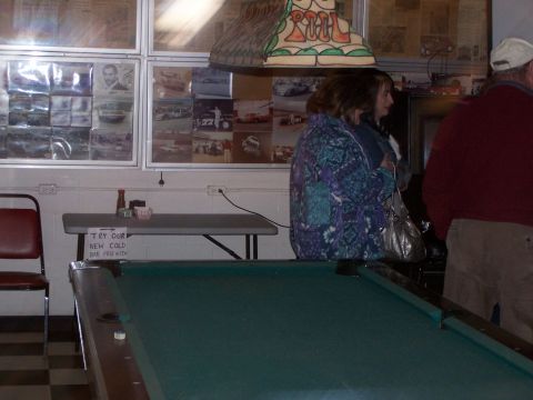 1971 Ford Ranchero - Interior view of a bar a pool table and walls adorned with numerous racing photographs.