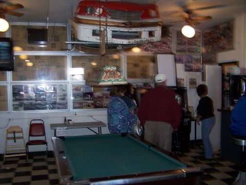 1971 Ford Ranchero - A car's front end is displayed as decor above a pool table in a room.