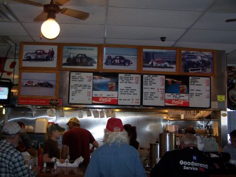 1971 Ford Ranchero - A diner scene framed photographs of vintage race cars displayed above the counter and menu boards.