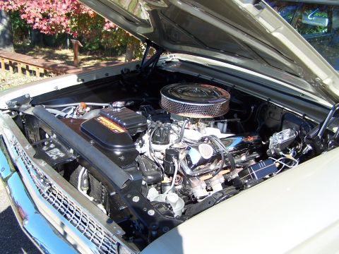 1971 Ford Ranchero - The engine compartment of a classic car is shown with the hood open, revealing the motor and surrounding components.