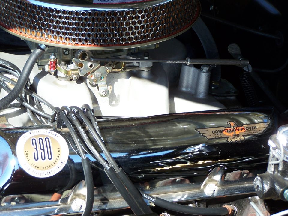 Close-up of engine showing a "390 CUBIC INCH DISPLACEMENT" badge and a "COMPETITION PROVEN" emblem