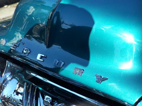 1971 Ford Ranchero - Close-up of a teal car's rear panel, showing the 'MERCURY' badging and chrome accents.