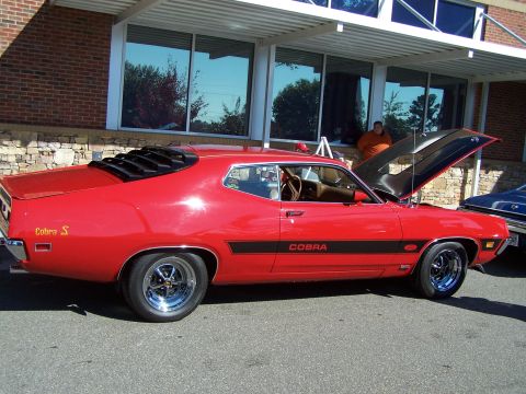 1971 Ford Ranchero - Red 1971 Ford Ranchero Cobra S parked outside a building with hood open.