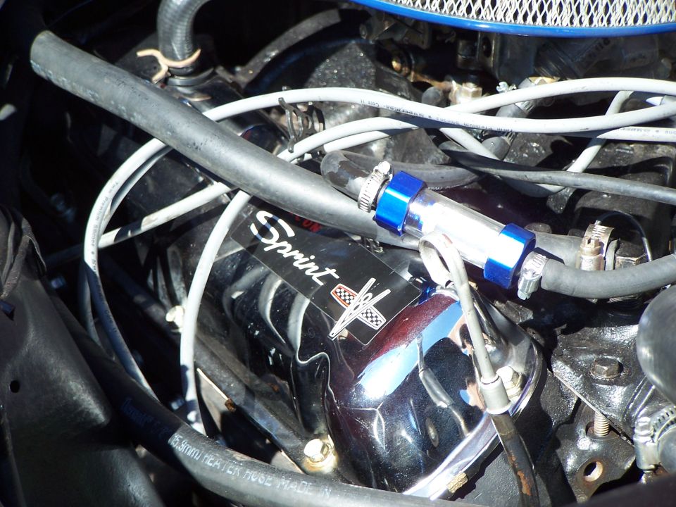 Chrome engine valve cover with 'Sprint' decal and checkered flag emblem