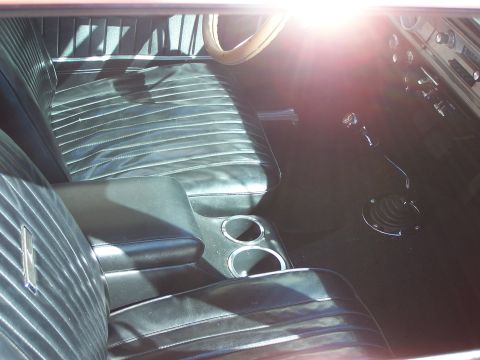 1971 Ford Ranchero - Interior view of a 1971 Ford Ranchero, showing the bench seat, dashboard, and floor shifter.