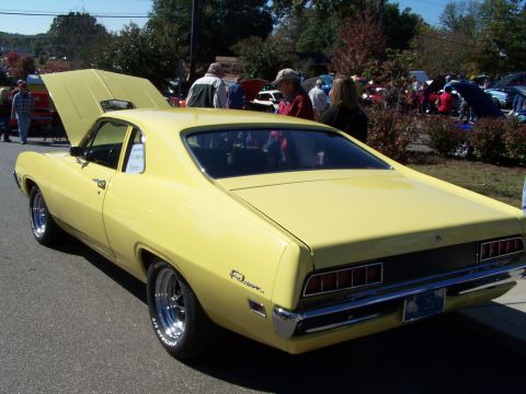 1971 Ford Ranchero - This yellow coupe utility vehicle, likely a 1970 model, is shown from the rear with "Ranchero" badging visible on the fender.