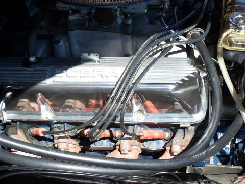 1971 Ford Ranchero - Engine bay detail showing chrome valve covers with 'Cobra' lettering and spark plug wires.