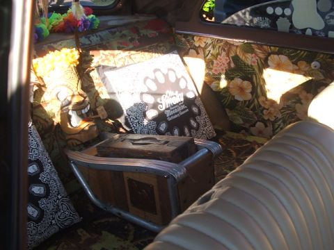 1971 Ford Ranchero - Custom interior features tropical patterns, a tiki mask, and a bandana, with a Supermotors logo in the corner.