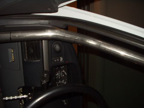 1993 Ford Bronco - A custom roll cage is installed inside the vehicle's interior, partially obscuring the dashboard and steering wheel.