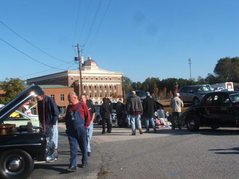 1971 Ford Ranchero - Several classic cars are on display outdoors with people milling about.