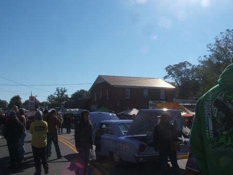 1971 Ford Ranchero - A light purple car from the 1950s is displayed with its hood open at an outdoor event.