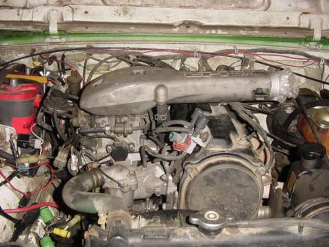 1992 Ford Bronco - A close-up view of a vehicle's engine bay, showing intricate mechanical details and wiring.