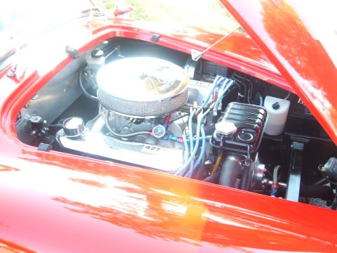 1971 Ford Ranchero - Close-up of a red vehicle's engine bay, showing a prominent air filter and "427" labeling.