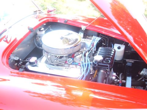 1971 Ford Ranchero - Engine bay of a red car, a prominent chrome air cleaner and a "427" badge, indicating a powerful V8 engine.
