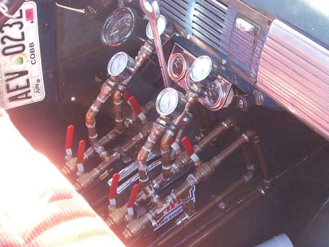 1971 Ford Ranchero - Custom air ride controls with gauges and valves. License plate AEV-023 is visible.