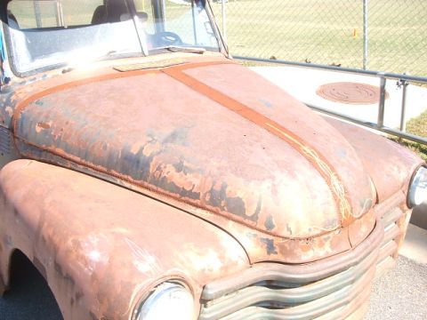 1971 Ford Ranchero - This old truck's hood shows significant rust and peeling paint, with a faded pinstripe design.