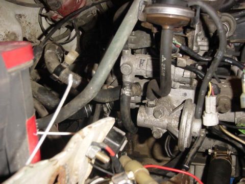 1992 Ford Bronco - Close-up view of engine bay components, including hoses and electrical connectors.