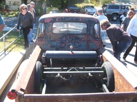 1971 Ford Ranchero - A weathered pickup truck with a custom air tank in the bed is viewed from the rear.