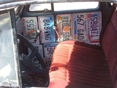 1971 Ford Ranchero - The interior of a vehicle is decorated with a collection of license plates from different states.