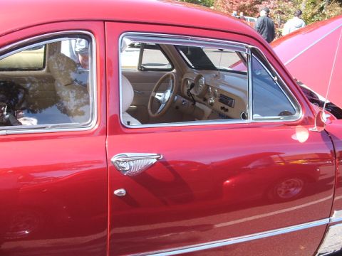 1971 Ford Ranchero - Interior view of a classic red car, showing dashboard, steering wheel, and door panel.