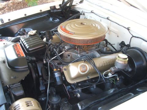 1971 Ford Ranchero - Close-up of a vehicle's engine bay, showing the "390" engine components and air filter assembly.