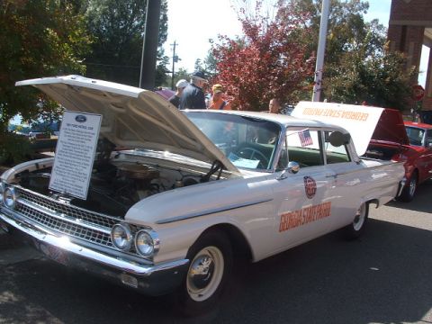 1971 Ford Ranchero - A white 1960 Ford Patrol Car, marked as Georgia State Patrol, is displayed with its hood and trunk open.