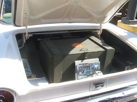1971 Ford Ranchero - A magazine 1961 Ford models is placed next to a large wooden crate in the trunk of a car.