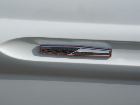 1971 Ford Ranchero - A close-up of a 'Grand Prix' emblem on a white vehicle's body panel.