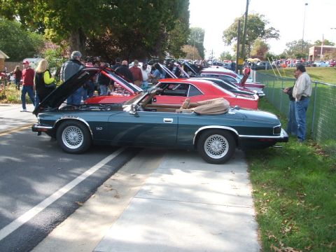 1971 Ford Ranchero - A dark green convertible is parked alongside other vehicles at an outdoor car show.