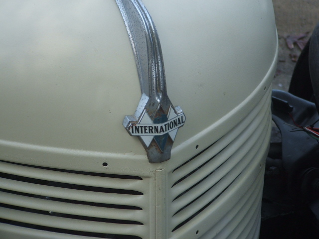 Cream-colored vehicle grille with horizontal slats and an 'International' emblem