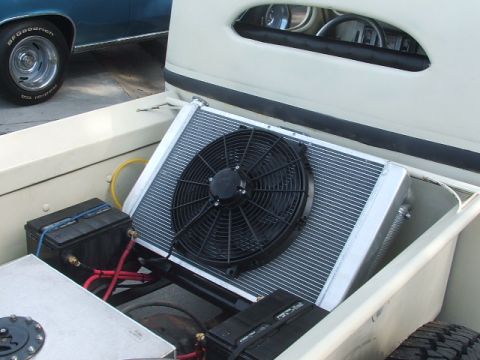1971 Ford Ranchero - Aftermarket cooling system components installed in the bed of a pickup truck, with another vehicle visible in the background.