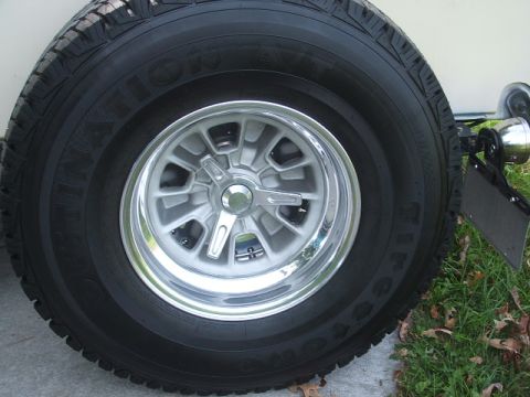1971 Ford Ranchero - A close-up view of a vehicle's wheel and tire, a distinctive silver multi-spoke rim with a chrome accent.