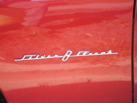1971 Ford Ranchero - Close-up of a chrome 'Silver 8' emblem affixed to the red body panel of a vehicle.