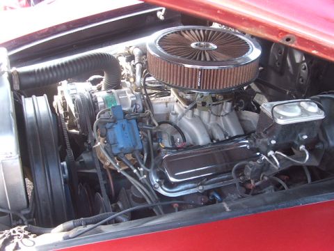 1971 Ford Ranchero - The engine bay of a red vehicle displays a V8 engine with aftermarket components.