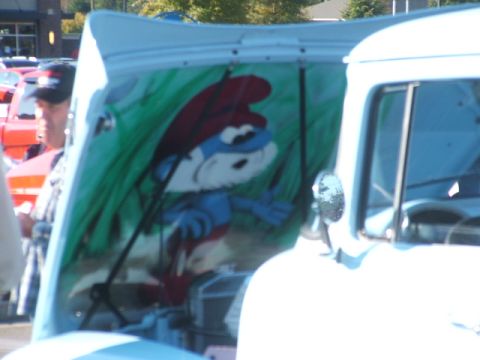 1971 Ford Ranchero - Custom artwork of a Smurf is painted on the underside of the hood of a white truck.