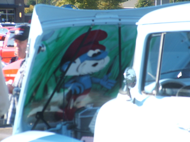 Smurf painted under hood of a white truck