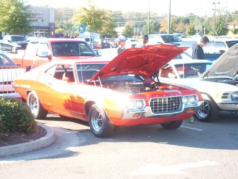 1971 Ford Ranchero - Orange 1971 Ford Ranchero on display with its hood up, parked at an outdoor event.