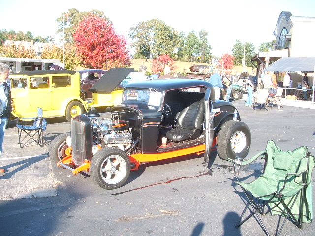 Hot rod coupe, front engine exposed, black with orange trim