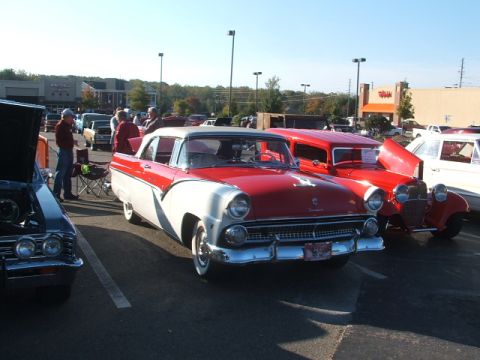 1971 Ford Ranchero - A two-tone red and white classic car is displayed at an outdoor event with other vehicles.